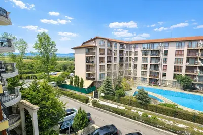 an apartment building with a swimming pool and a parking lot at Harmony Suites-2 Private Apartment 404 in Sunny Beach