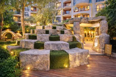 a rock garden in front of a building at Harmony Suites-2 Private Apartment 404 in Sunny Beach