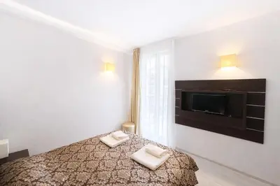 a bedroom with a bed and a flat screen tv at Harmony Suites-2 Private Apartment 404 in Sunny Beach