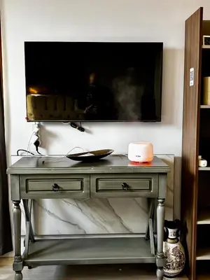 a table with a tv on top of a wall at Golden Nest B25 in Nesebar