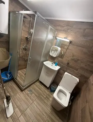 a bathroom with a shower and a toilet and a sink at Студио-Джени in Burgas City