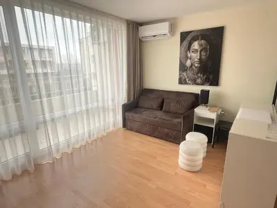 a living room with a couch and a window at Nessebar Fort Club in Sunny Beach