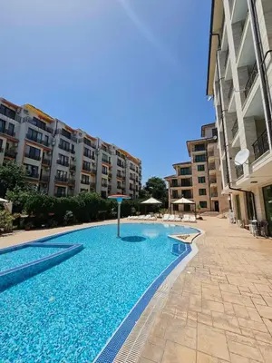 a swimming pool in front of some apartment buildings at Amadues Lux, 1 Bed - Central to Sunny Beach in Sunny Beach
