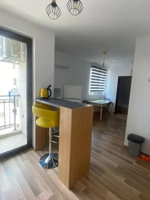 a kitchen with a yellow island in a room at Amadues Lux, 1 Bed - Central to Sunny Beach in Sunny Beach