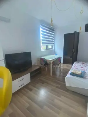 a bedroom with a bed and a television and a table at Amadues Lux, 1 Bed - Central to Sunny Beach in Sunny Beach