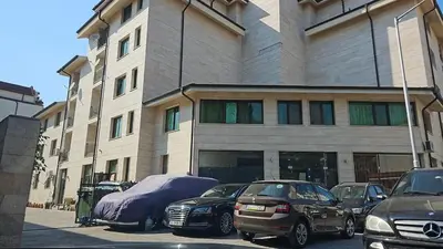 a building with cars parked in front of it at Amadues Lux, 1 Bed - Central to Sunny Beach in Sunny Beach