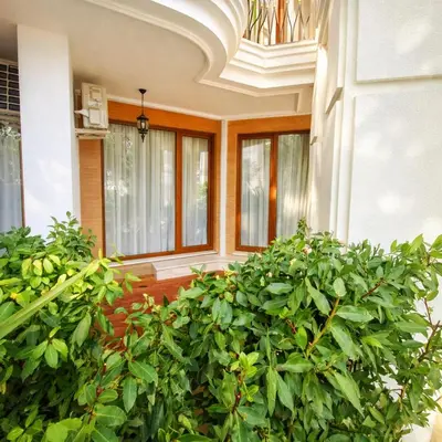 a building with a bunch of green plants in front at Harmony Suites Grand Resort-15 Private Apartment in Sunny Beach