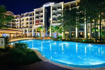 a large blue swimming pool in front of a building at Harmony Suites Grand Resort-15 Private Apartment in Sunny Beach