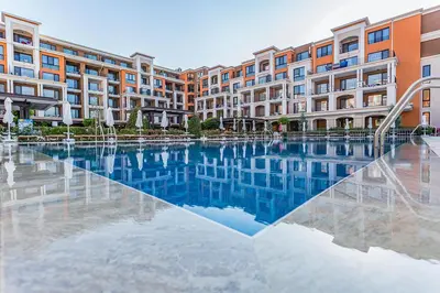 a large swimming pool in front of a building at Premier Fort Beach Aparthotel - Sunny Beach in Sveti Vlas