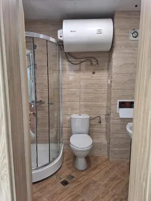 a small bathroom with a toilet and a shower at Premier Fort Beach Aparthotel - Sunny Beach in Sveti Vlas