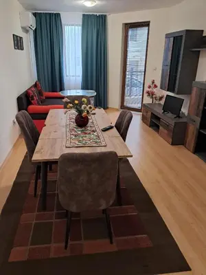 a living room with a table and a couch at Apartment in Byala Vista Compex in Byala