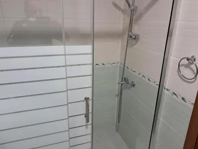 a shower with a glass door in a bathroom at Apartment in Byala Vista Compex in Byala