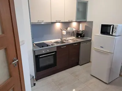 a kitchen with a sink and a stove and a refrigerator at Apartment in Byala Vista Compex in Byala