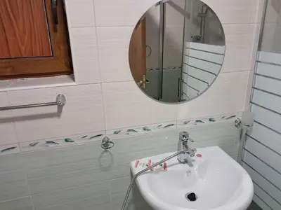a bathroom with a sink and a mirror at Apartment in Byala Vista Compex in Byala