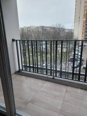 a balcony with a railing with a view of a parking lot at Izgrev View apartment bs in Burgas City