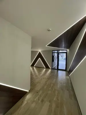 an empty room with a wooden floor and a ceiling at Izgrev View apartment bs in Burgas City
