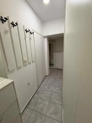 a bathroom with white cabinets and a tile floor at Dimitrov cathedral apartament in Varna City
