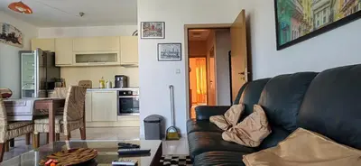 a living room with a couch and a kitchen at Luxury apartment opposite Kakao in Sunny Beach