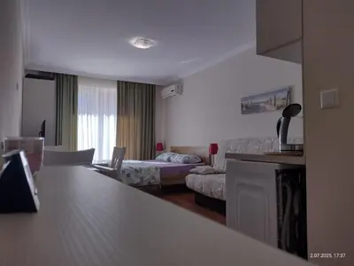 a hotel room with a living room with a bed and a kitchen at Marvel Deluxe in Sunny Beach