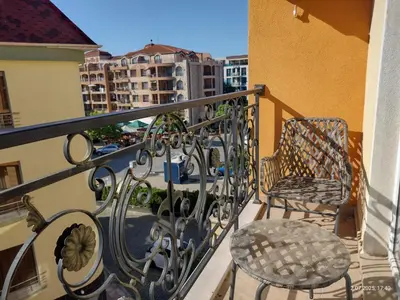 a balcony with two chairs and a table on a balcony at Marvel Deluxe in Sunny Beach