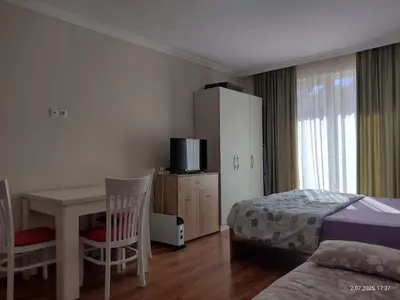 a bedroom with a desk and a bed and a bed and a table at Marvel Deluxe in Sunny Beach