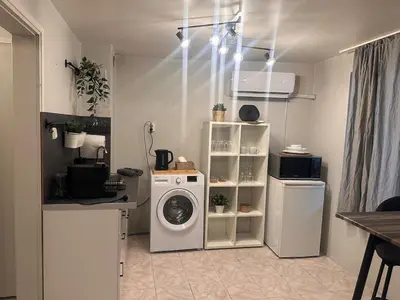 a laundry room with a washing machine and a washer at Top Center Apartment in Varna City