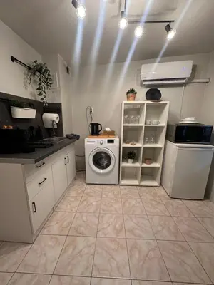 a kitchen with a washer and dryer in a room at Top Center Apartment in Varna City