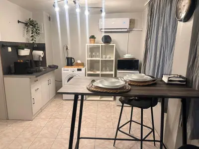 a kitchen with a table with plates on it at Top Center Apartment in Varna City