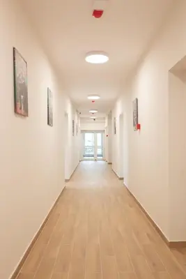 an empty hallway with paintings on the walls at Леглото in Topoli