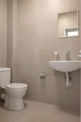 a bathroom with a toilet and a sink at Леглото in Topoli