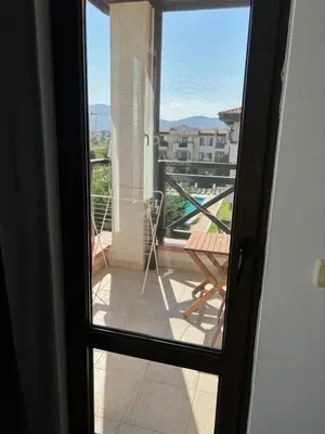 a door to a balcony with a view of a patio at Beachside apartment - 100 meters from the sea in Chernomorets