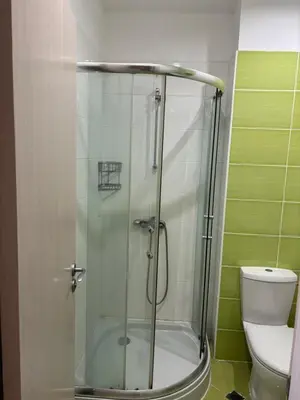 a glass shower in a bathroom with a toilet at Beachside apartment - 100 meters from the sea in Chernomorets