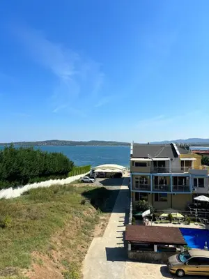 a house with a swimming pool next to the ocean at Beachside apartment - 100 meters from the sea in Chernomorets