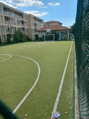 a tennis court with a net on a court at Слънчев бряг Sunny day 6 One bedroom apartment in Sunny Beach