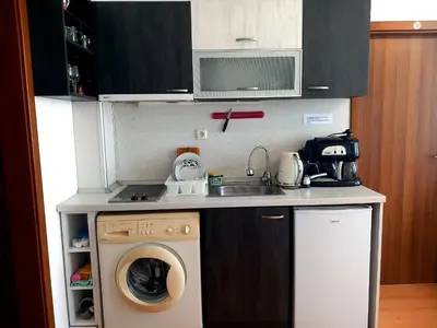 a small kitchen with a washing machine and a sink at Слънчев бряг Sunny day 6 One bedroom apartment in Sunny Beach