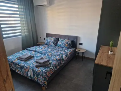 a bedroom with a bed with towels on it at Family House Burgas in Burgas City
