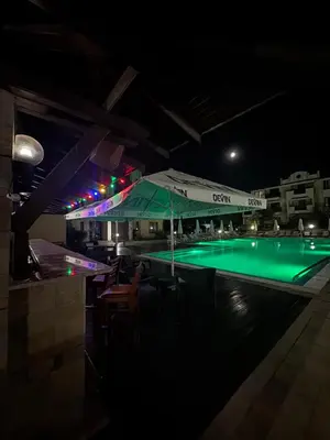 a swimming pool at night with a green illumination at Sunny sea apartment - 100 meters from the sea in Chernomorets