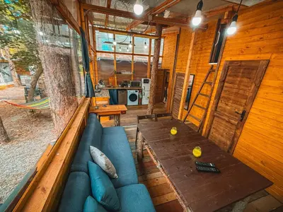 a living room with a blue couch and a table at Бунгало Борче in Burgas City