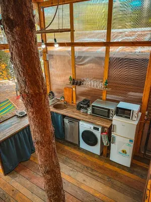 a kitchen with a stove and a sink in a room at Бунгало Борче in Burgas City