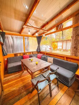 a living room with a table and a couch at Бунгало Борче in Burgas City