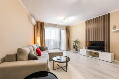 a living room with a couch and a tv at Seaside Bliss in Varna City