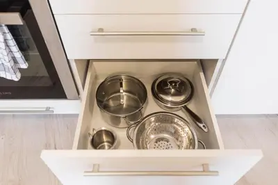 a kitchen drawer with pots and pans in it at Seaside Bliss in Varna City
