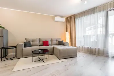 a living room with a couch and a table at Seaside Bliss in Varna City