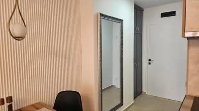 a mirror is on a wall in a room at Vladan apartments in Sozopol