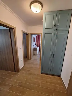 a hallway with a large green cabinet and a tile floor at 3 Room Apartment with Poolview in Cascadas Resort in Sunny Beach