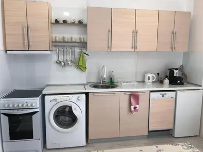 a kitchen with a washing machine and a sink at Calendula in Burgas City