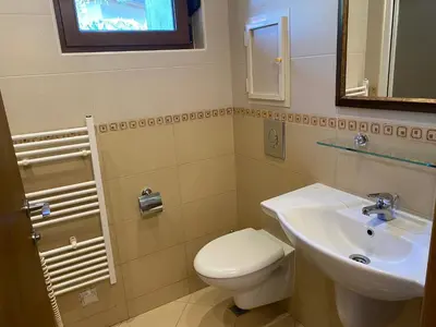 a bathroom with a white toilet and a sink at AJ Apartment 3, Santa Marina Holiday Village, Sozopol in Sozopol
