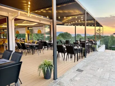 a restaurant with tables and chairs on a patio at AJ Apartment 3, Santa Marina Holiday Village, Sozopol in Sozopol