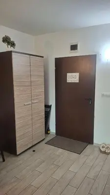 a large wooden door in a room with a floor at Апартамент in Burgas City