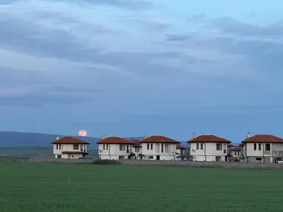 a row of houses in the middle of a field at Villa LUNA in Kableshkovo